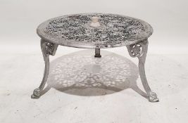 Modern metal garden table with umbrella attachment and pierced decoration