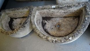 Pair of composite stone planters of semi-circular form, 18cm high x 63cm long approx. (2)