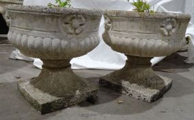 Pair of composite stone urns, 36cm high approx. (2)