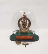 Brass skeleton timepiece with single pointed steeple, on four supports to stained wood base under