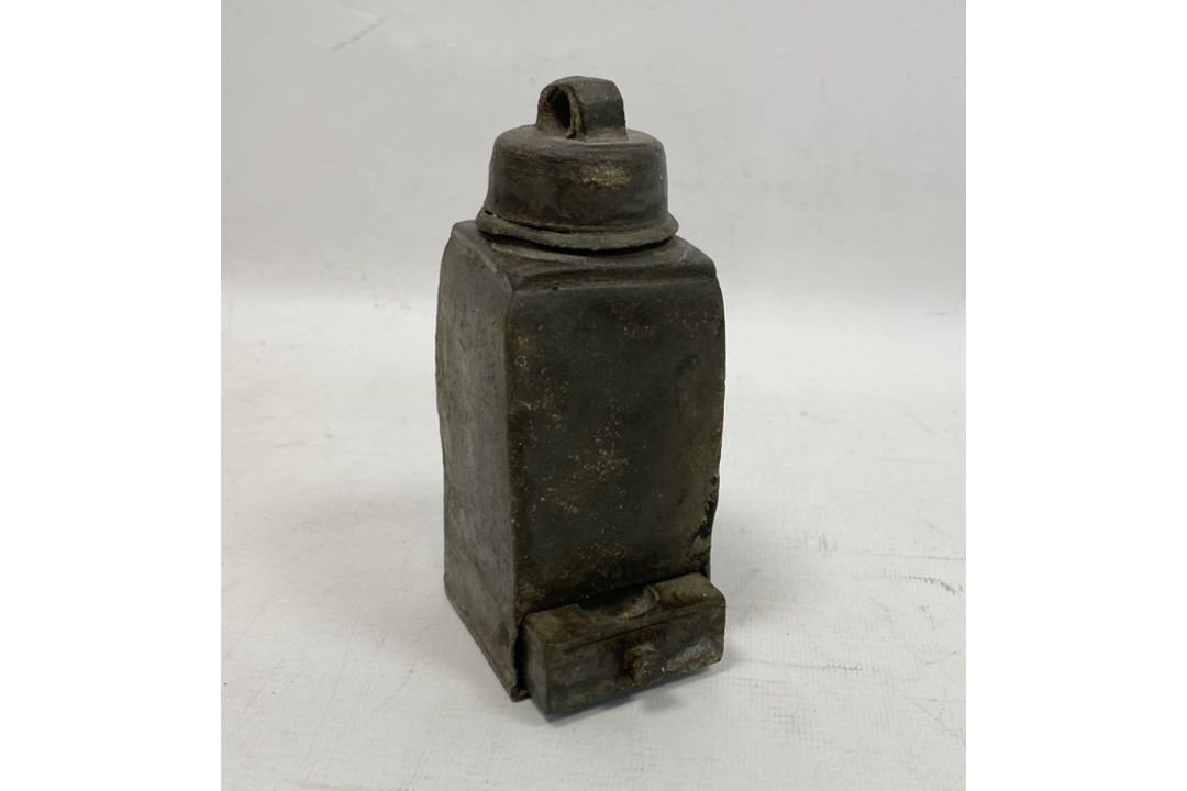 An unusual lead object, with a screw lid and handle and a small drawer below, 14cm high, 5.5cm