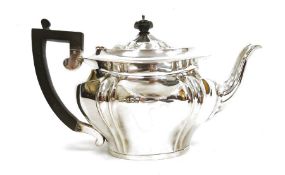 Silver teapot, oval and serpentine-shaped, Birmingham 1909, with ebonised handle, 18ozt approx.