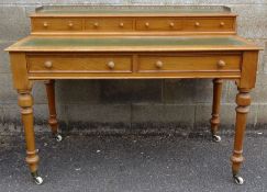 Victorian pine desk by Heal & Son, London, the three-quarter pierced brass gallery above the leather