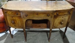 Regency mahogany sideboard of serpentine front with reeded edge, single drawer above tambour-fronted