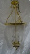 Reproduction Georgian-style hanging lantern of circular form, brass mounts with a glass shade and