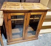 Vintage pine two-door cabinet, the rectangular top above two glazed doors enclosing shelves, to