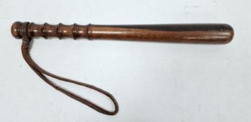 Carved wooden truncheon with wrist strap, 38cm