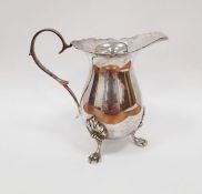 Modern silver Georgian-style cream jug with serpentine everted rim, scroll handle, on three
