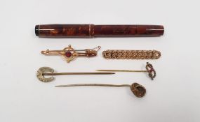 9ct gold bar brooch set with circular red stone and metal clasp, a gold-coloured chain-link bar