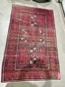 Eastern style red ground rug with central geometric pattern with multiple geometric borders 236cm