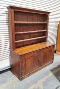 Late 19th century oak dresser, the top section with moulded cornice above three shelves and two