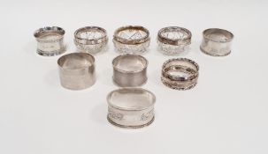Three silver-rimmed cut glass personal salts and six various silver napkin rings