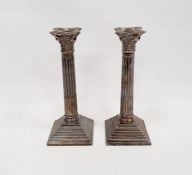 Pair of 1960's silver weighted Corinthian column candlesticks with on a square stepped base, maker