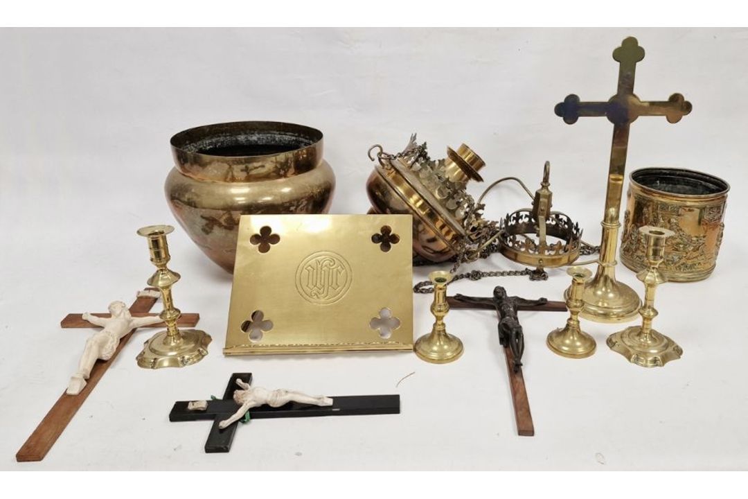 Brass cross, brass fretwork ceiling lamp, pair of brass candlesticks, a brass bucket with embossed