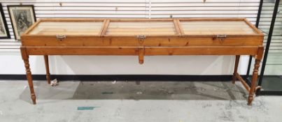 Pine three-section haberdashery counter-top cabinet with three separate glazed lift-top sections, on