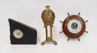 An Art Nouveau brass clock on twin supports with triform base, the mount decorated with female