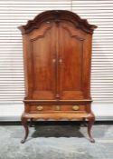 19th century continental armoire on stand, having broken-arch and cavetto cornice, shelves