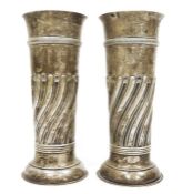 Pair of Victorian large silver vases, cylindrical repousse decorated on circular feet, London 1897