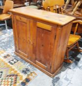 Stained pine two-door cupboard, on plinth base