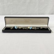 Silver charm bracelet with Pandora type silver and enamel and ceramic charms