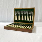 A cased canteen of plated fish eaters with ivory type handles