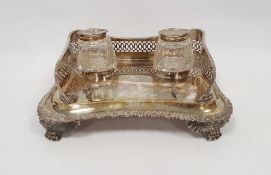 George III silver inkstand with two glass and lidded silver inkwells, the shaped rectangular stand