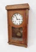 A substantial industrial style wall clock in oak veneered case, plain white painted dial with
