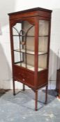 Edwardian display cabinet with ogee moulded pediment above astragal-glazed door enclosing shelves,