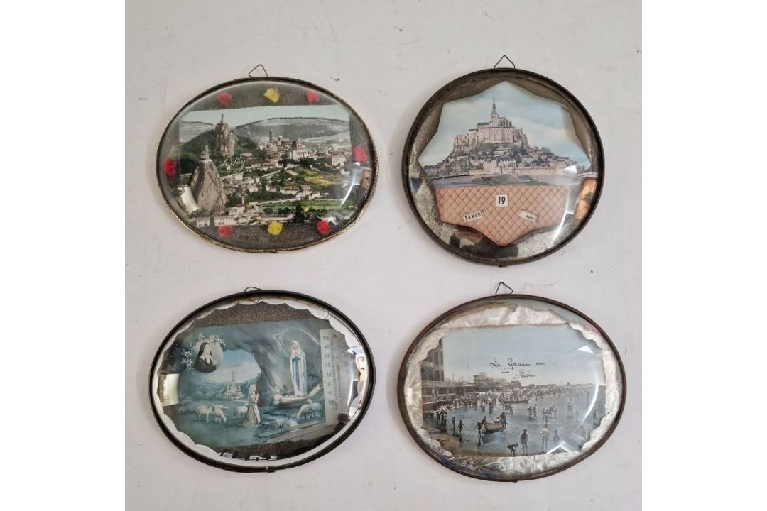Four various oval set frames with glass domed fronts, printed continental scenes