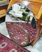 Large circular bevelled plate wall mirror and a smaller oval mirror with paper label to back '