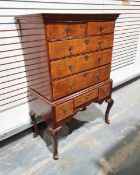 Georgian walnut chest on stand with moulded cornice above two short drawers and three long graduated