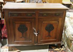 Mahogany sideboard with two drawers above pair of foliate carved cupboards, on square supports,
