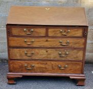 Georgian mahogany bureau with two short over three long drawers, swan-neck brass handles, ogee