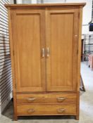 Modern oak two section wardrobe, the cupboard over two long drawers on square feet, H. 200cm x W.