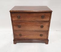 Stained wood chest of three drawers, with brass ring handles and stamped backplates, on bracket