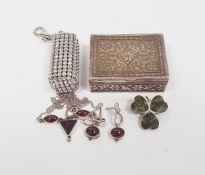 Silver four-leaf clover brooch, a silver and garnet-coloured necklace with matching earrings, a