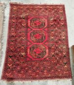 Eastern style red ground rug with three elephant foot guls to multiple geometric borders, 180cm X