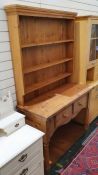 Pine dresser with ogee moulded cornice above three shelves, on rectangular moulded base above two