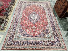 Central Persian Kashan red ground carpet with central floral medallion enclosed by floral pattern to