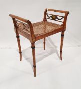 French-style window bench with cane seat and painted floral and cherub decoration on tapering