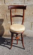 19th century rosewood child's correctional chair, bar backed, on oval cream upholstered seat,