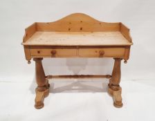 Pine washstand having raised back with two frieze drawers, bun handles, on baluster supports, turned