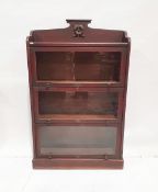 Edwardian dark stained Globe Wernicke-style three-tier bookcase with flowerhead carved roundel to