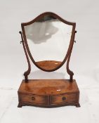 Walnut toilet mirror, the shield-shaped plate on serpentine fronted base with two drawers, pair