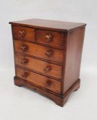 Miniature stained pine chest of two short over three long drawers with turned bun handles, 37cm x