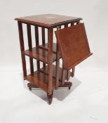 Oak revolving bookcase with fold out book rest and metal plaque with inscription to top