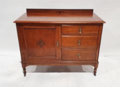 Oak sideboard, on rectangular moulded top above three drawers flanked by one cupboard, on turned and