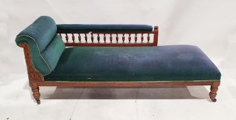 Mahogany-framed and green upholstered chaise longue on castors