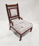 Oak salon chair on turned front legs to castors