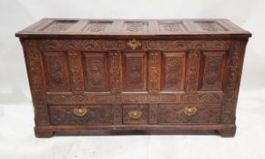 Antique oak dower chest with fielded panels and later carving, later dated 